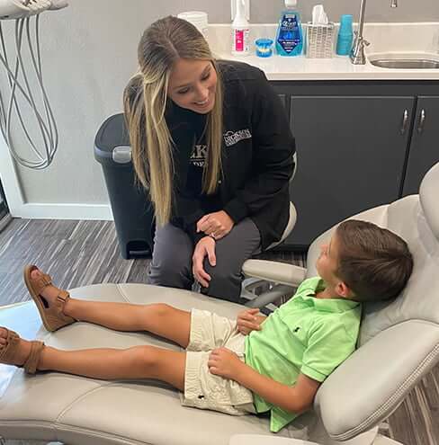 hygienist speaking with a young patient