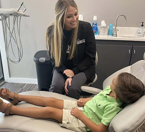 staff member speaking with a young patient