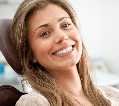 smiling woman sitting in a dental chair