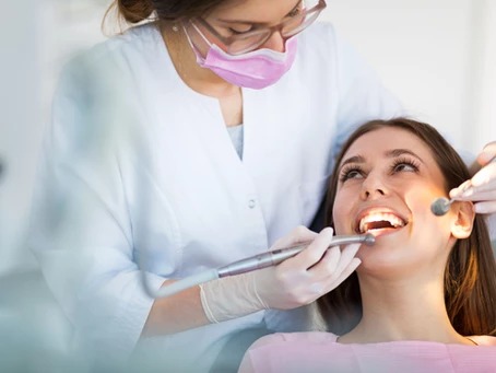 woman having her teeth examined by a dentist