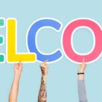 Hands holding the word welcome with multicolored letters