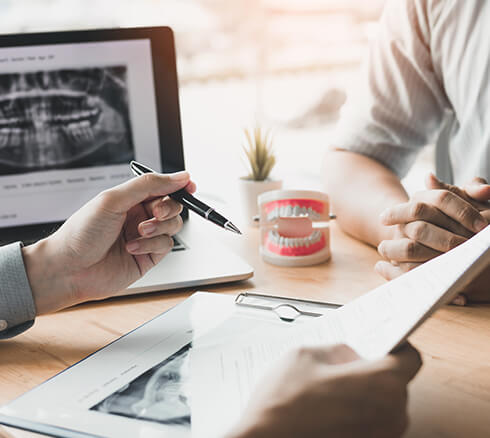 two people going over dental paperwork