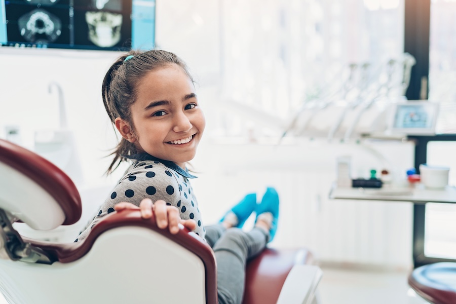 young girl in dentist chair at family dentist