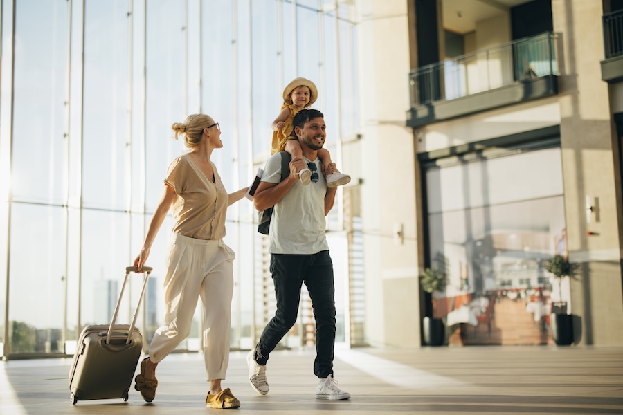 family traveling in airport needing to keep up their dental health while on vacation