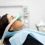 woman using nitrous oxide dental sedation at the dentist for dental anxiety